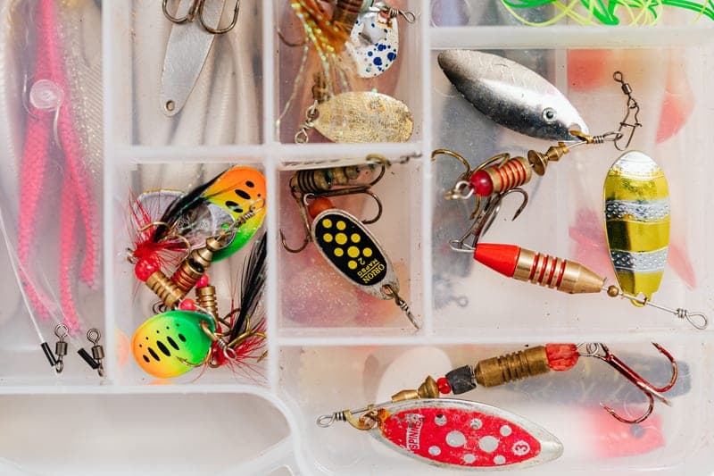 A tackle box and fishing equipment laid out