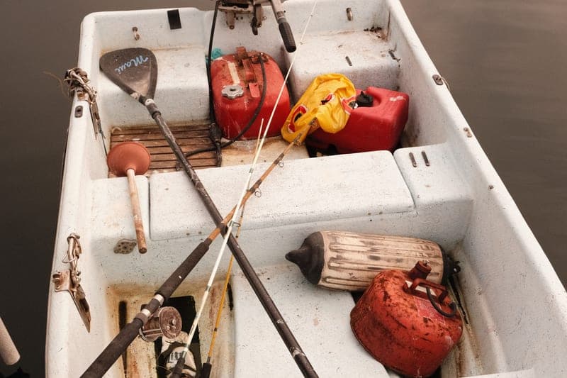Fishing rods held upright in holders on a boat