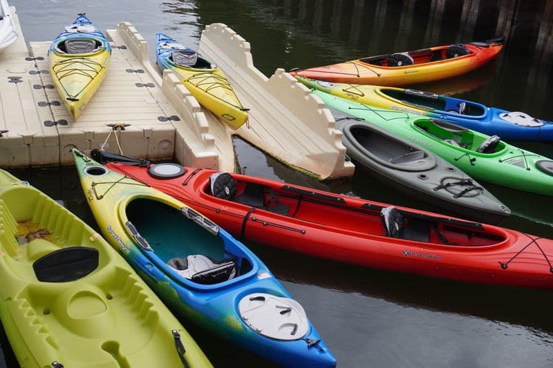 Paddling gear laid out on a wooden dock
