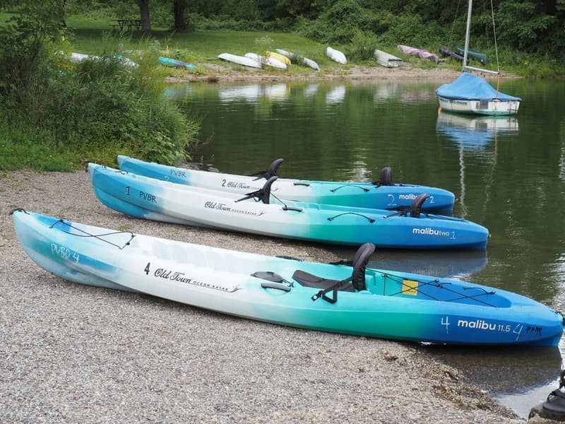 A weathered kayak resting on a shoreline