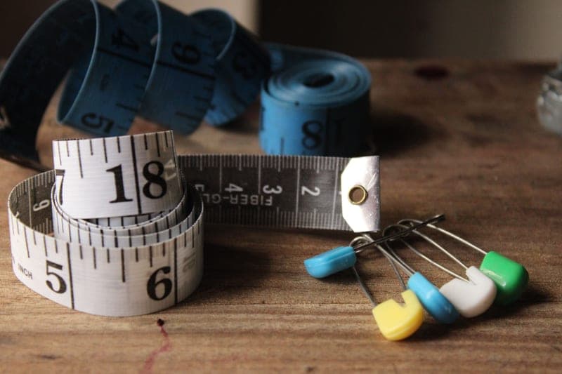 A tape measure and tools on a workbench