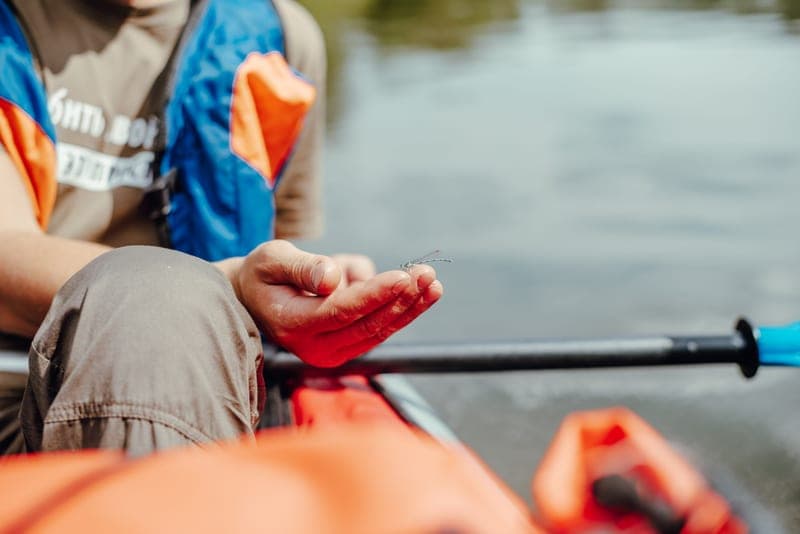 A paddler in a life vest on a river
