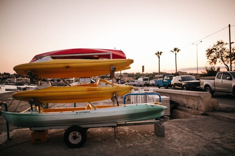 Two kayaks carried on the roof of a vehicle