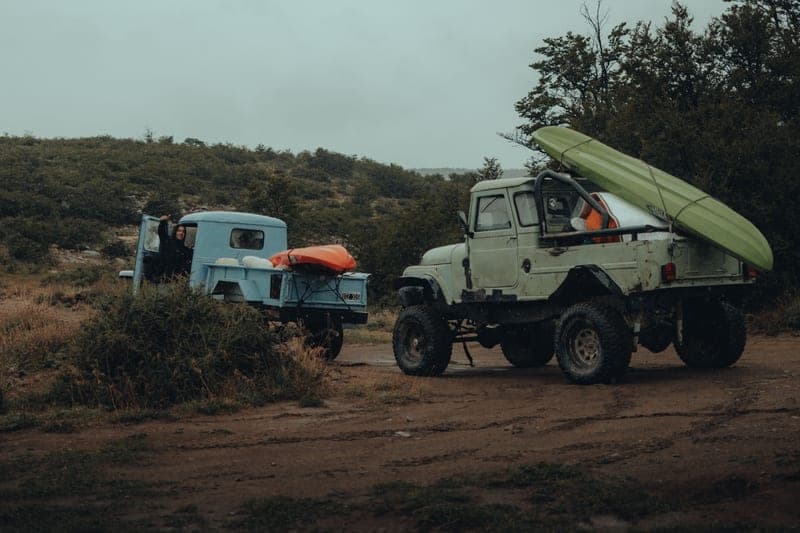 A kayak loaded in the bed of a pickup truck